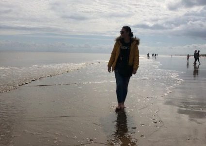 IMG_1889-1 Person walking on a beach with reflection on wet sand or shallow water